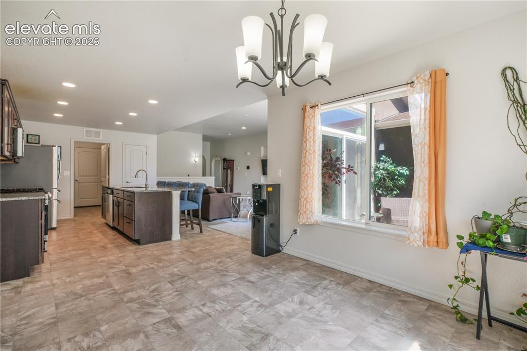 Image 14 of 50: Dining area with large windows