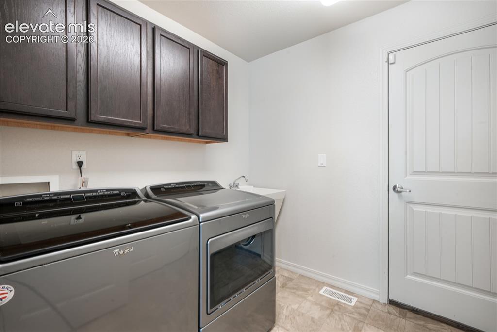 Image 16 of 50: Main floor laundry room, access to the garage