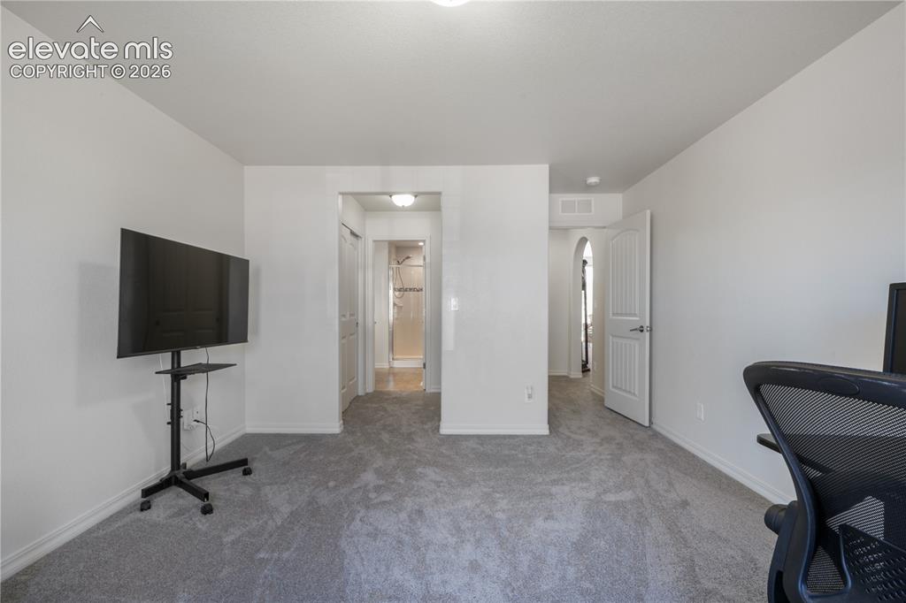 Image 25 of 50: Main level 2nd bedroom with ensuite 3/4 bathroom, dual closets and new carp