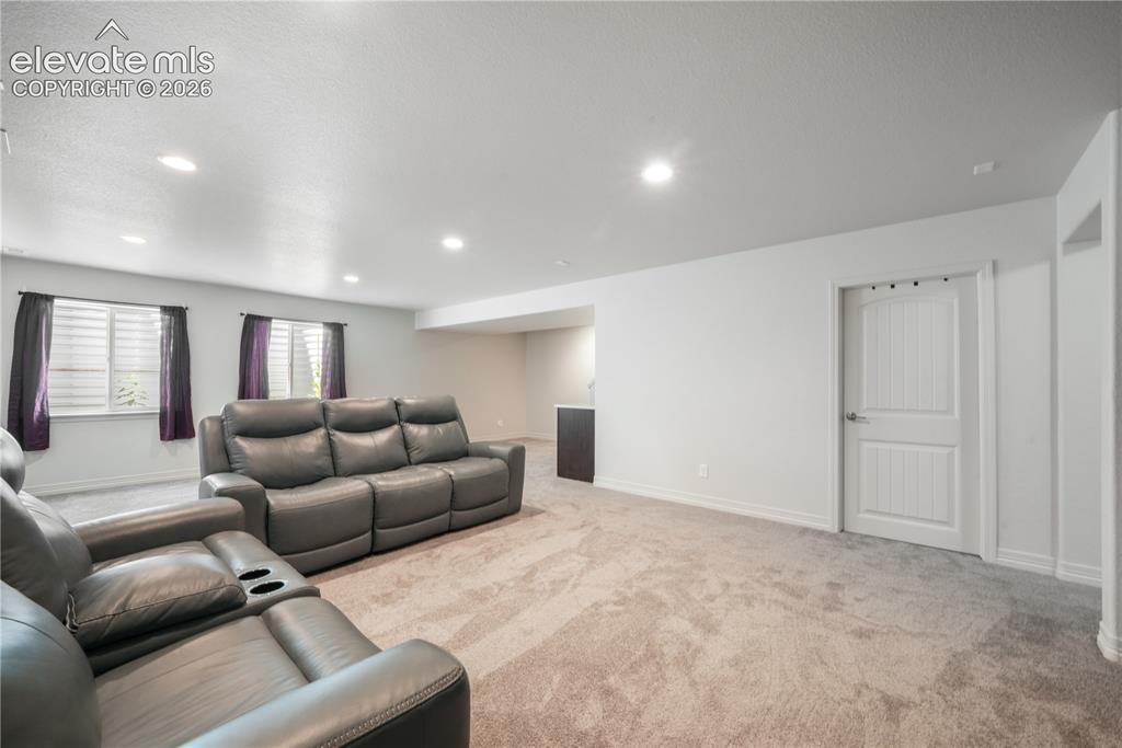 Image 32 of 50: Basement family room with mini wet bar, new carpet