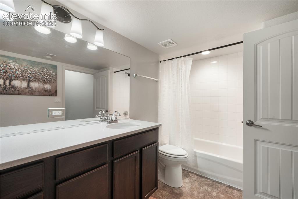 Image 37 of 50: Basement full bathroom with quartz countertops