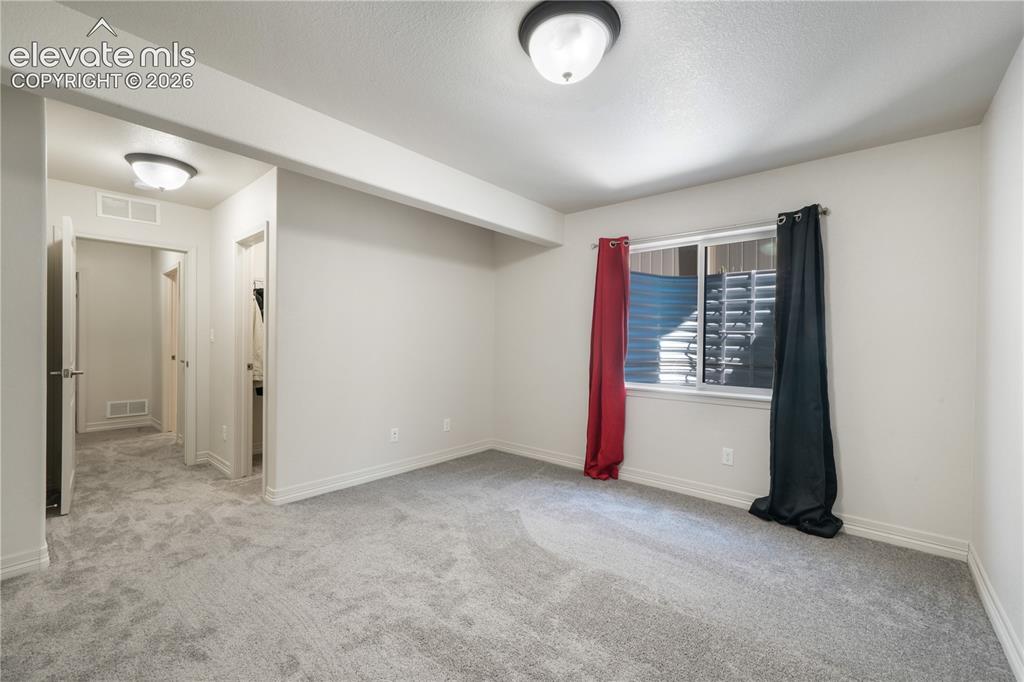 Image 38 of 50: Basement 4th bedroom with large walk in closet and new carpet