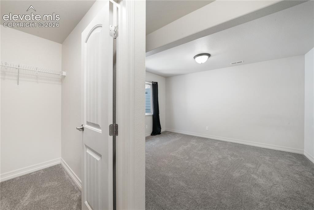 Image 39 of 50: Basement 4th bedroom with large walk in closet and new carpet