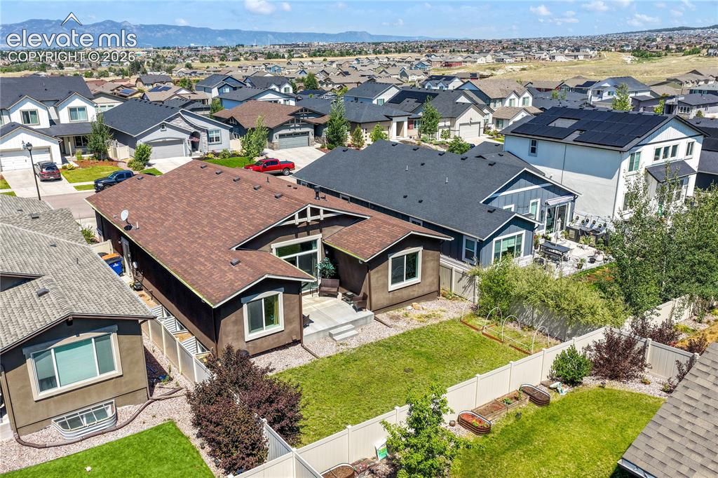 Image 47 of 50: Back aerial view showing landscaping and mountain views