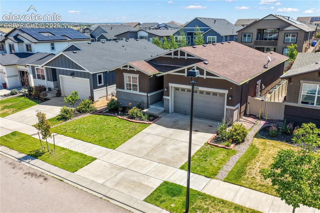 Image 49 of 50: Front aerial view showing landscaping and 2 car garage