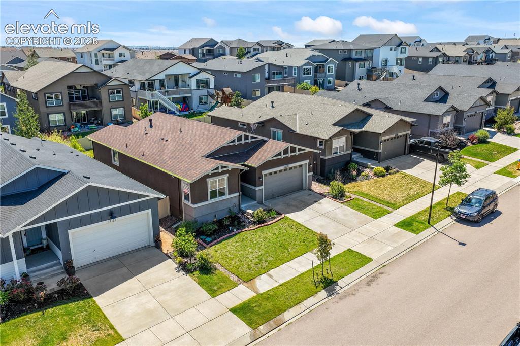 Image 50 of 50: Front aerial view showing landscaping, 2 car garage and neighborhood