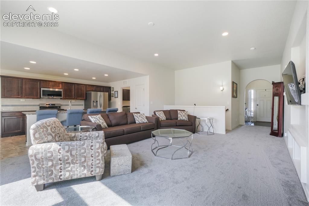 Image 6 of 50: Livingroom with open concept, gas fireplace, large patio sliding doors and