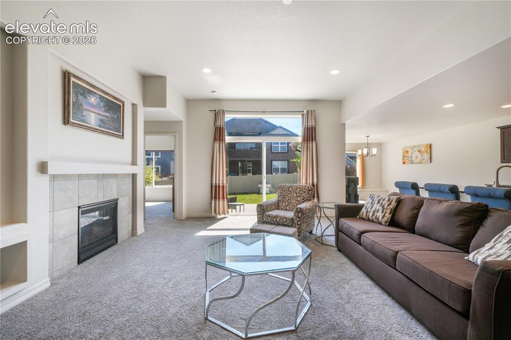 Image 8 of 50: Livingroom with open concept, gas fireplace, large patio sliding doors and