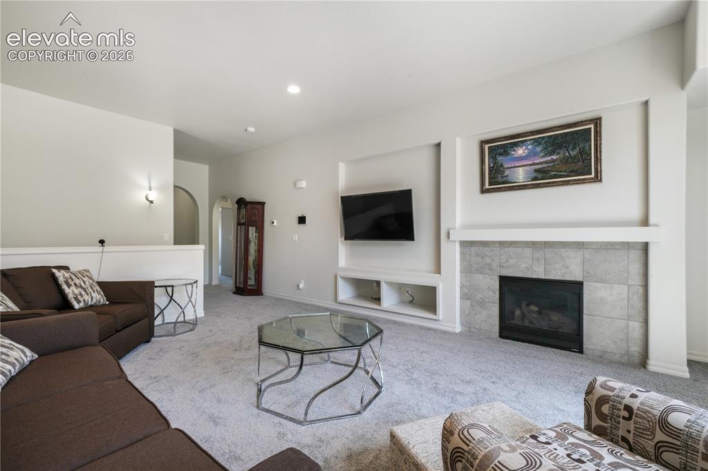 Image 9 of 50: Livingroom with open concept, gas fireplace, large patio sliding doors and