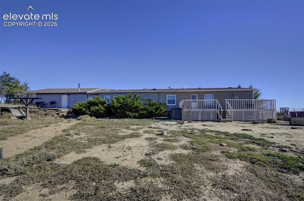 Image 31 of 31: Back of property with a wooden deck