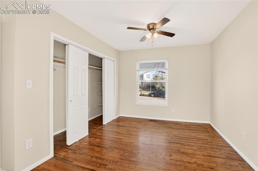 Image 14 of 42: Master bedroom show cases original hardwood
