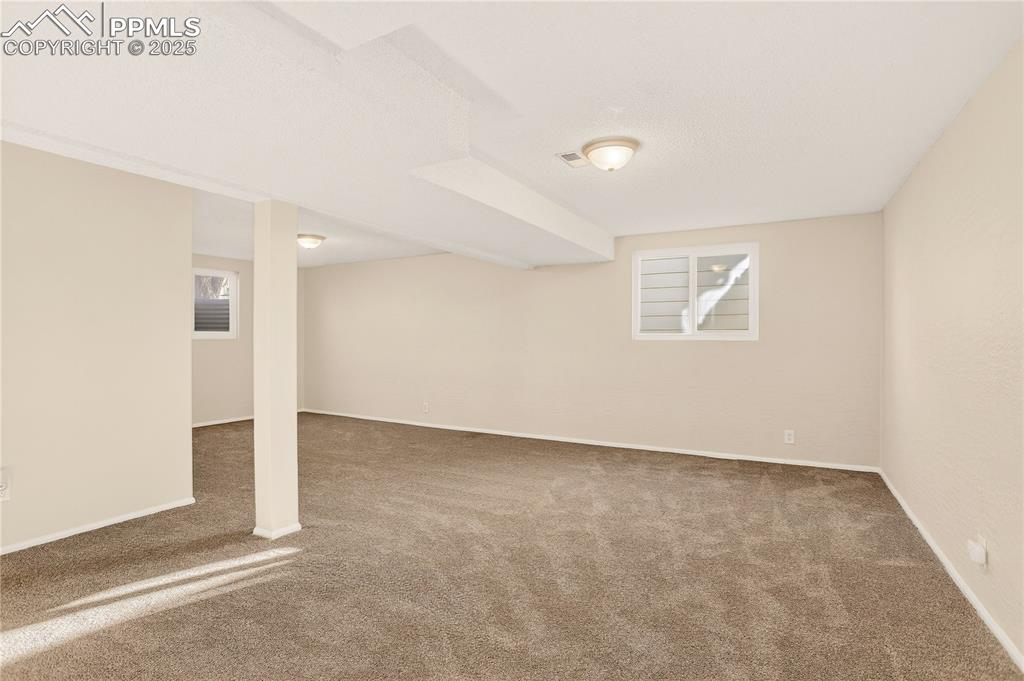 Image 21 of 42: Family room has newer carpet