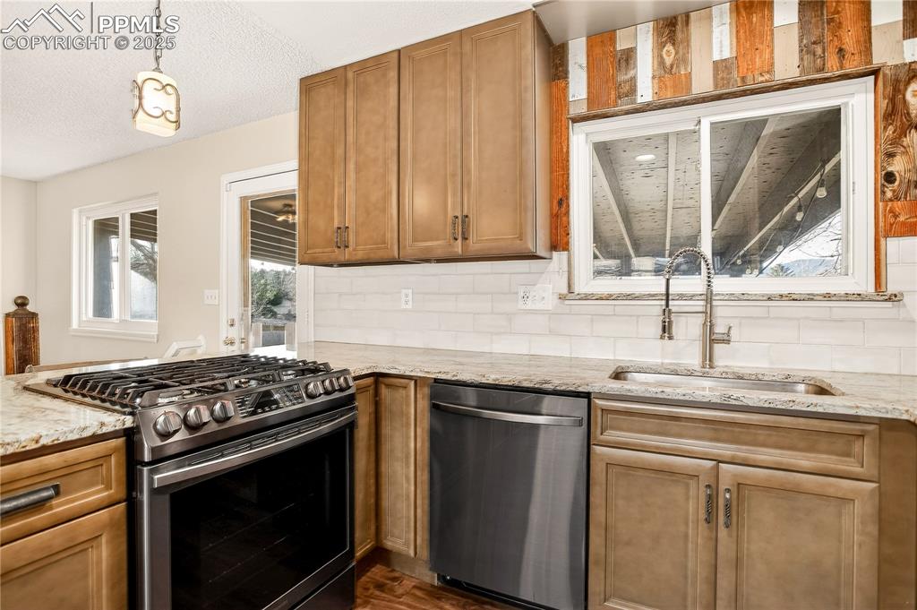 Image 3 of 42: Kitchen with newer ss appliances:  gas stove, dishwasher, microwave, refrig