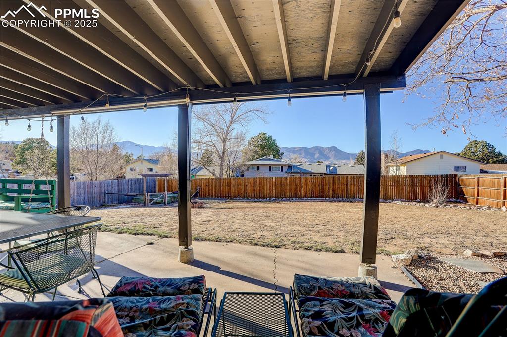 Image 32 of 42: Covered back patio features magnificent MT views
