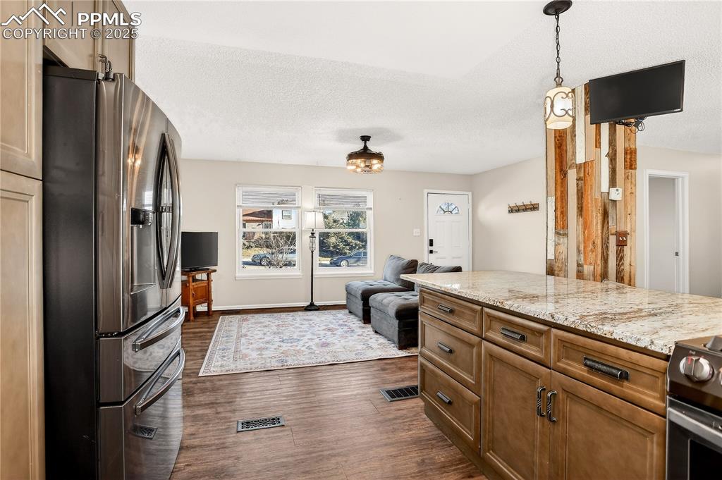 Image 4 of 42: Kitchen flows into living and dining rooms