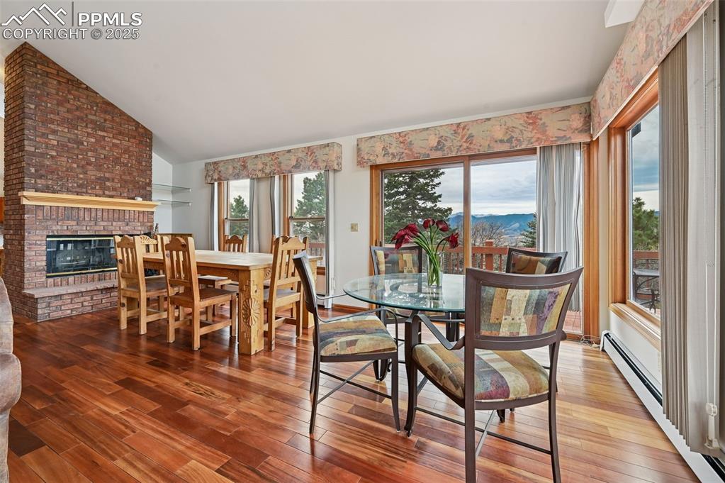 Image 17 of 49: Dining room with baseboard heating, plenty of natural light, lofted ceiling