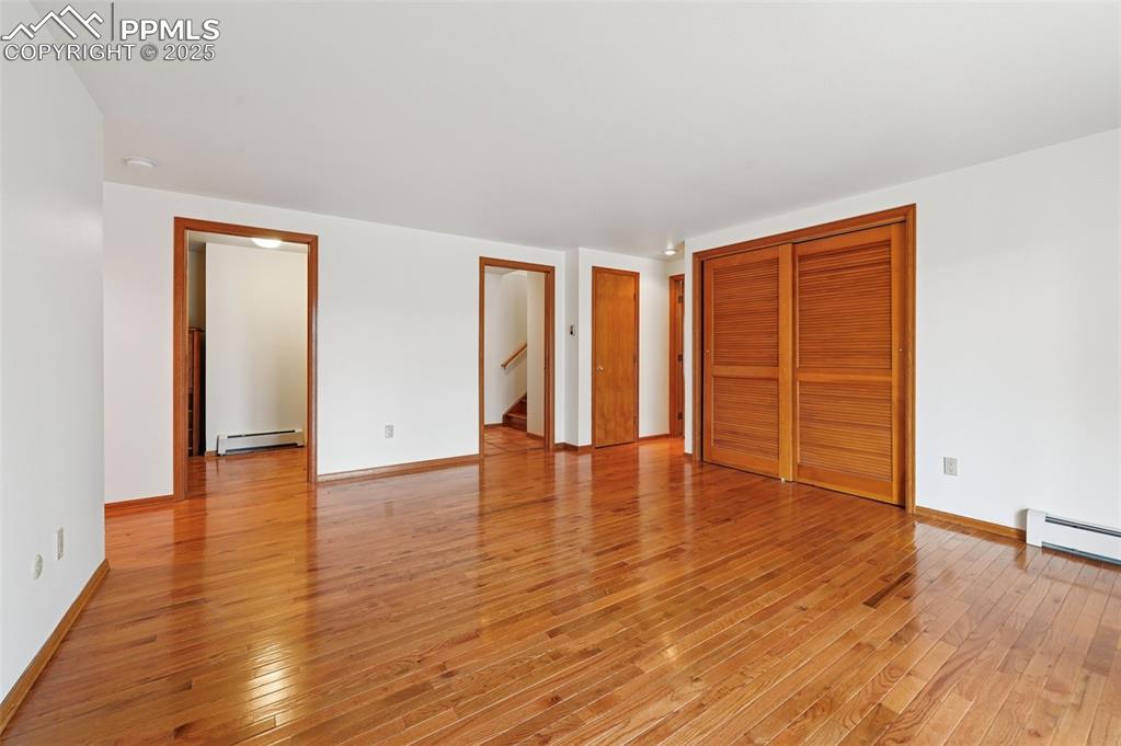 Image 37 of 49: Unfurnished bedroom with light wood-type flooring, a closet, and baseboard 