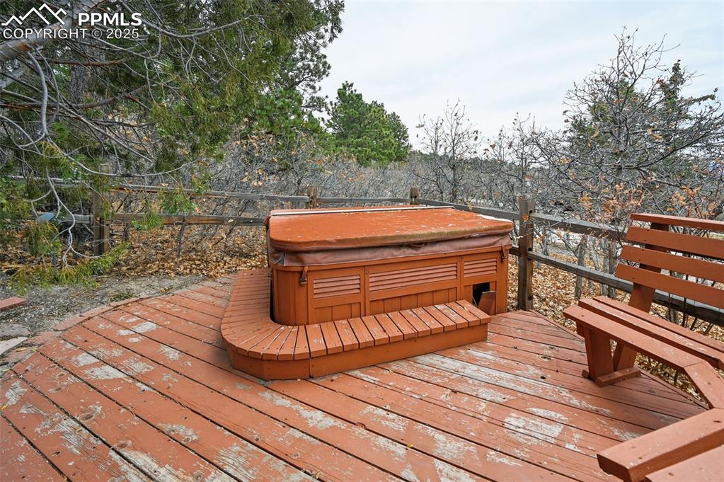 Image 9 of 49: Deck with a hot tub