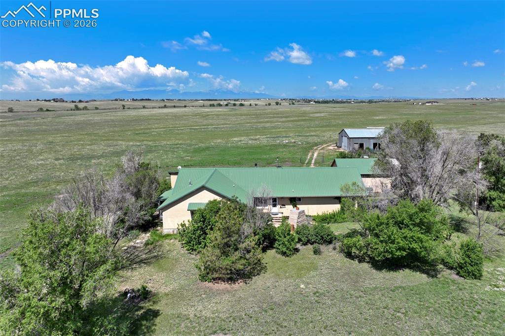 Image 1 of 50: Expansive property featuring a single-story residence with a green metal ro