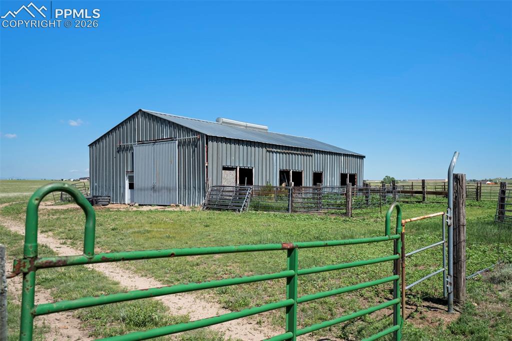 Image 10 of 50: Galvanized metal barn featuring a pitched roofline and multiple window open