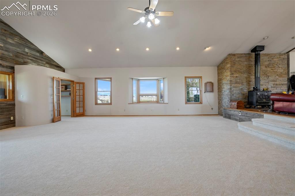 Image 17 of 50: Spacious main living area featuring vaulted ceilings with recessed lighting