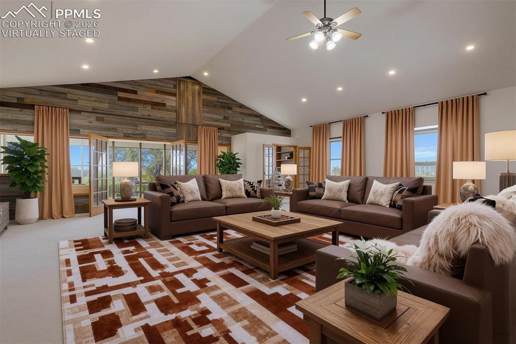 Image 18 of 50: virtually staged Spacious living area featuring a vaulted ceiling, recessed