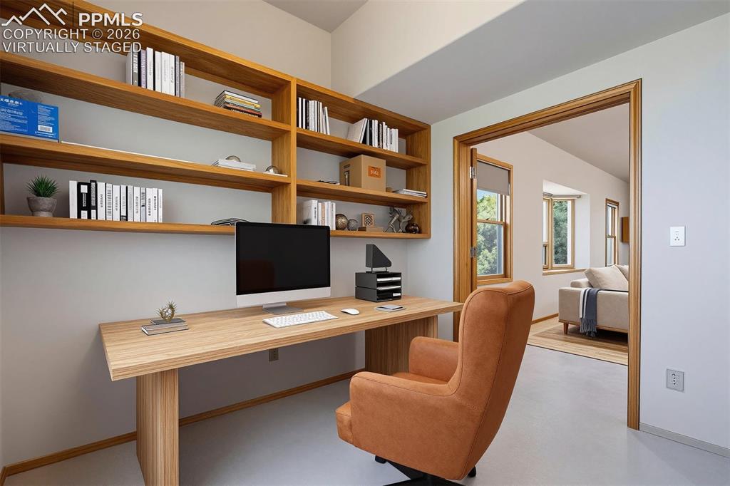 Image 22 of 50: virtually staged Built-in wood-finish shelving and desk unit