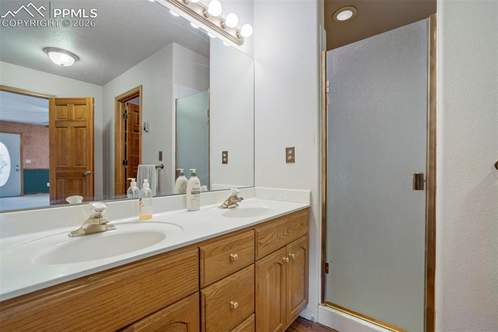 Image 38 of 50: Double vanity with integrated sinks and a large wall-mounted mirror