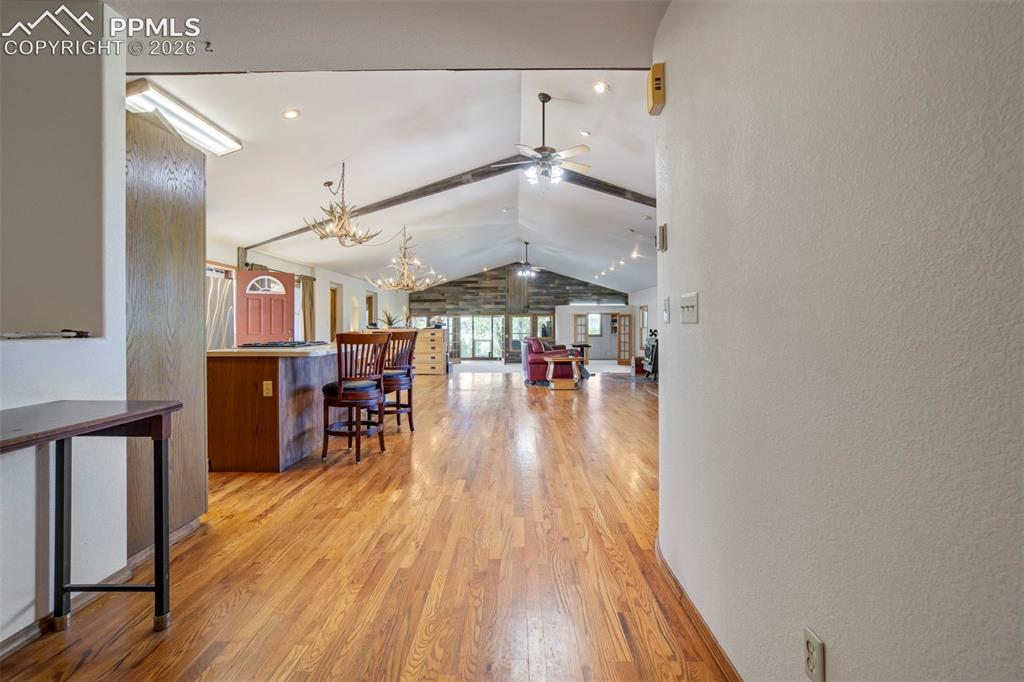 Image 40 of 50: Spacious interior featuring wood-finish flooring, vaulted ceilings with exp