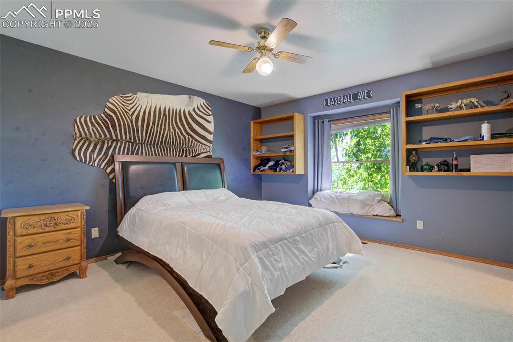 Image 41 of 50: Spacious room featuring light-toned carpeting, a window with a sill, a ceil