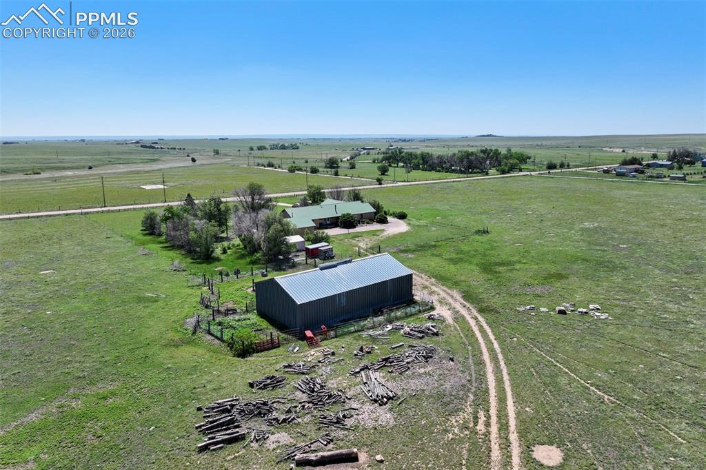 Image 5 of 50: Expansive rural property featuring a main residence with a green roof, a la