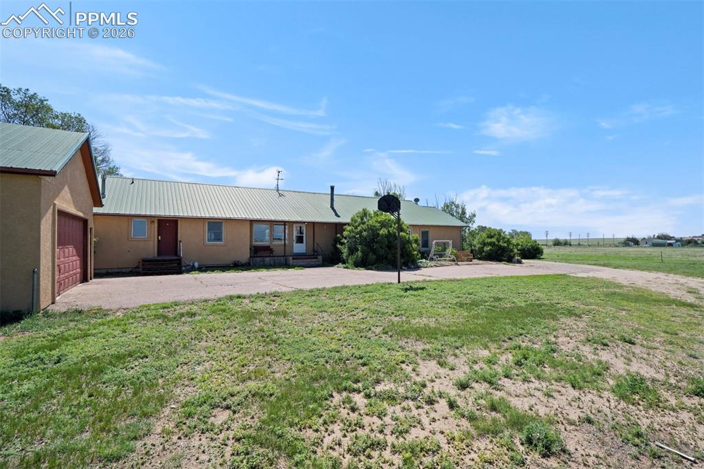 Image 8 of 50: Ranch-style residence featuring a stucco exterior and an attached garage wi