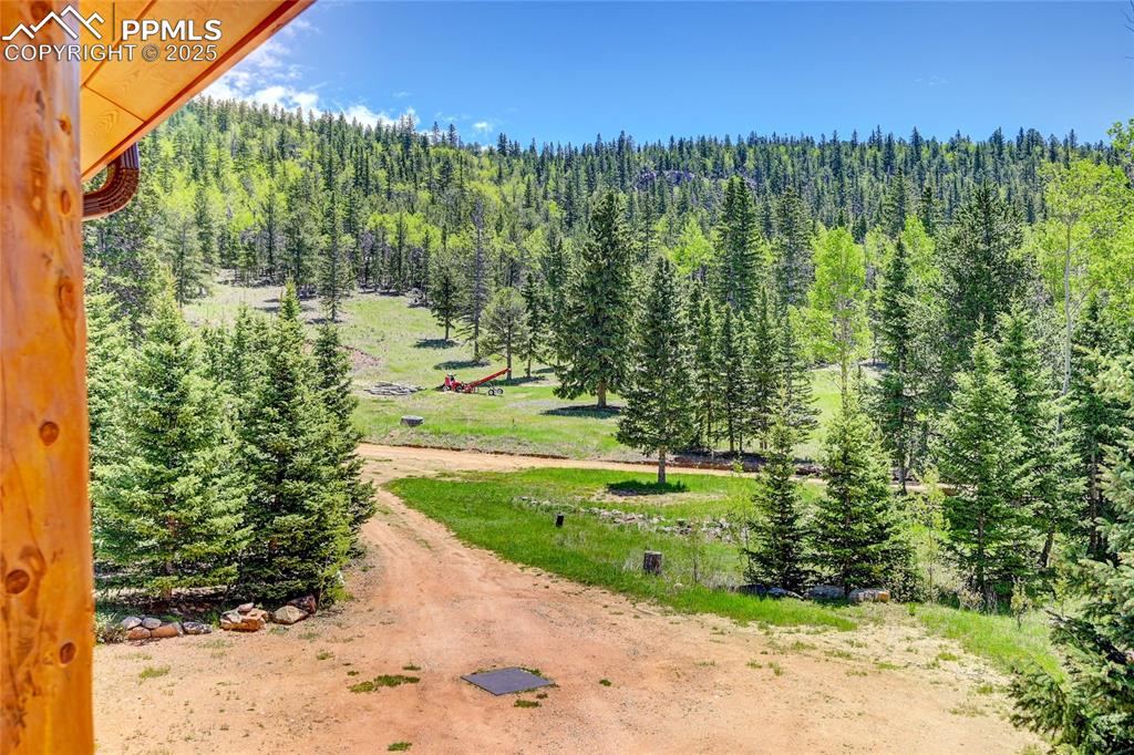Image 5 of 50: Birds eye view of property with a wooded view