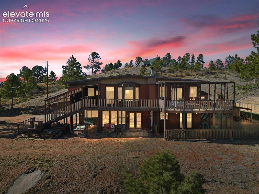 Image 1 of 49: twilight elevated photo of deck, main floor and lower level