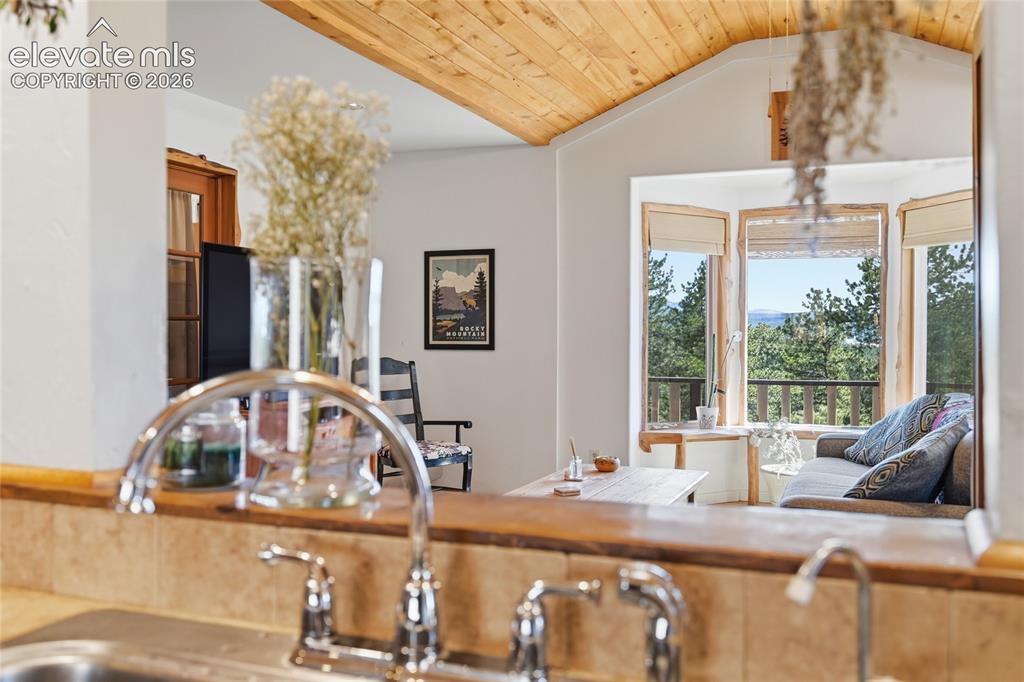 Image 10 of 49: View from the kitchen into the living room and through gabled windows
