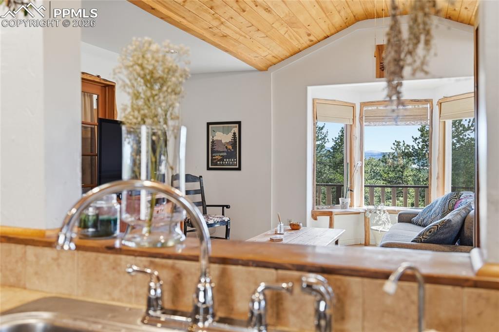 Image 11 of 50: View from the kitchen into the living room and through gabled windows

