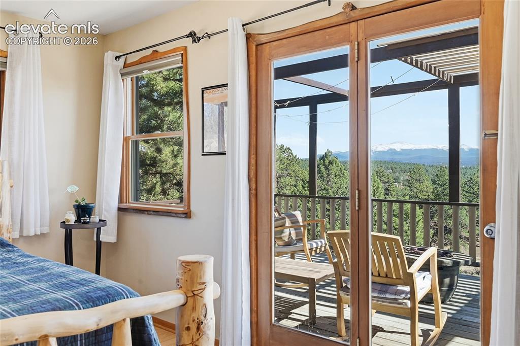 Image 12 of 49: Fantastic view of deck and surrounding area from the bedroom