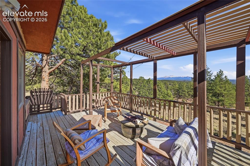 Image 19 of 49: Large deck with firepit for entertaining.