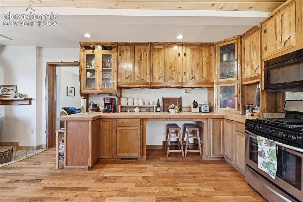 Image 19 of 49: View from the kitchen entrance. More custom cabinets!