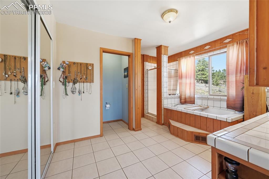 Image 20 of 49: En suite bathroom with jet tub