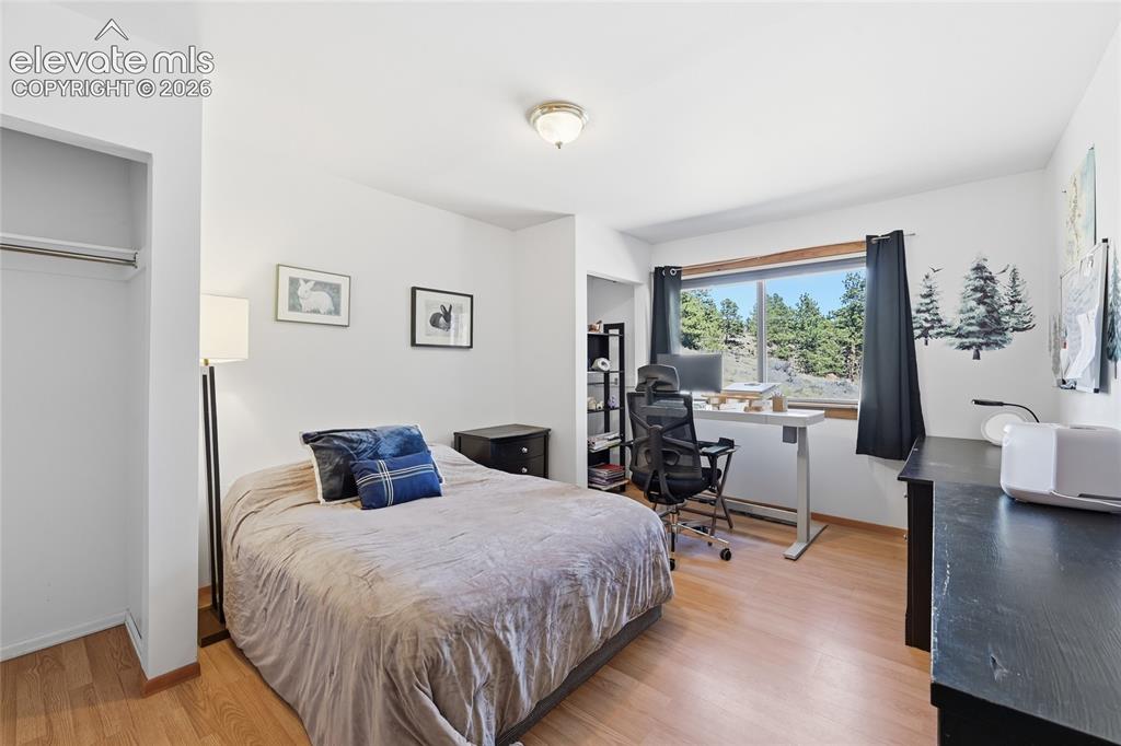 Image 24 of 49: Upstairs guest bedroom, has great view of the property.