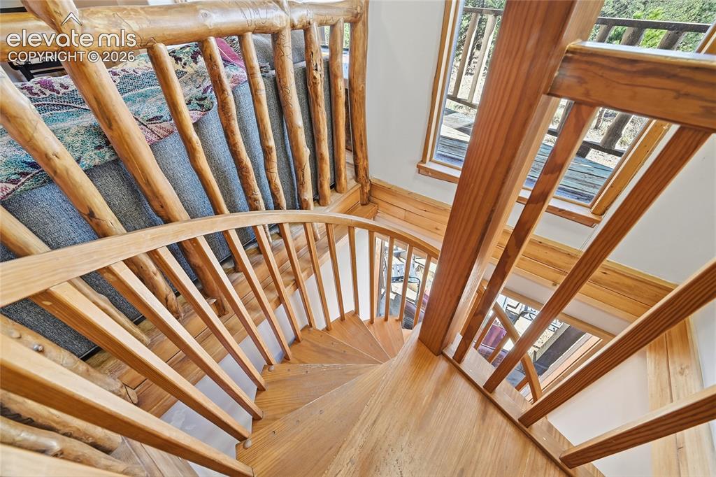Image 26 of 49: Custom wood staircase to basement level