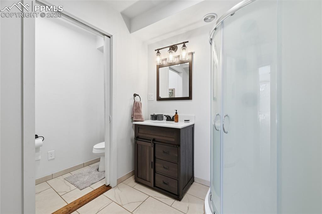 Image 33 of 50: Lower level unattached bathroom.