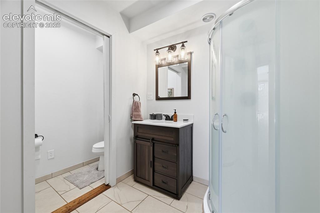 Image 33 of 49: Lower level unattached bathroom.
