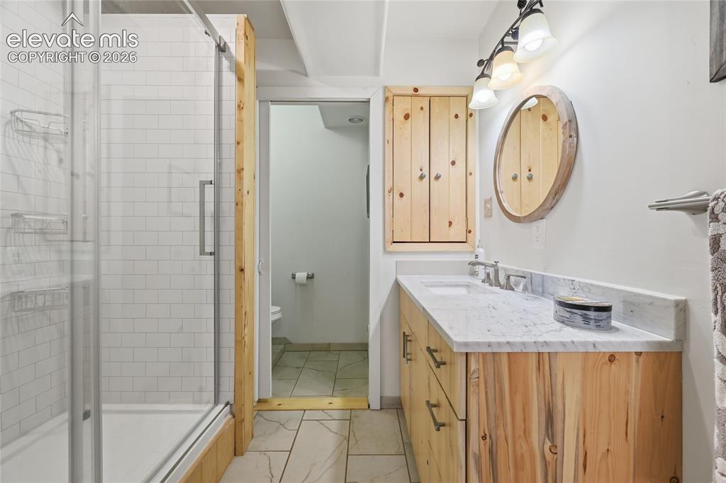 Image 35 of 49: Lower level bathroom attached to bedroom 3.