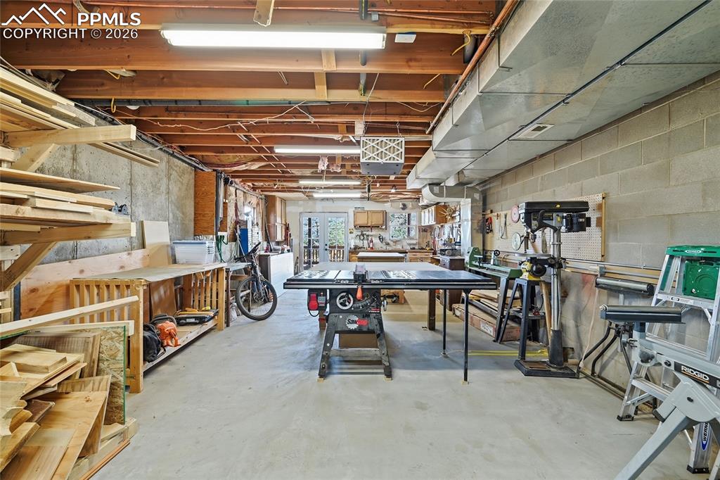 Image 36 of 50: View of the workshop from the rear area.  All tools except the table saw re