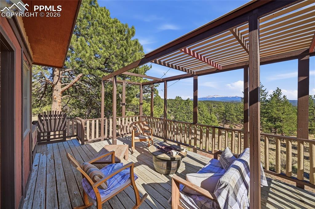 Image 6 of 50: Large deck with firepit for entertaining.