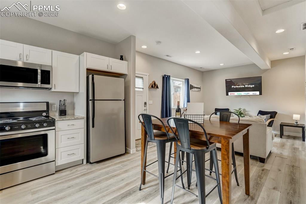 Image 43 of 46: Cottage kitchen and view of dining and living area
