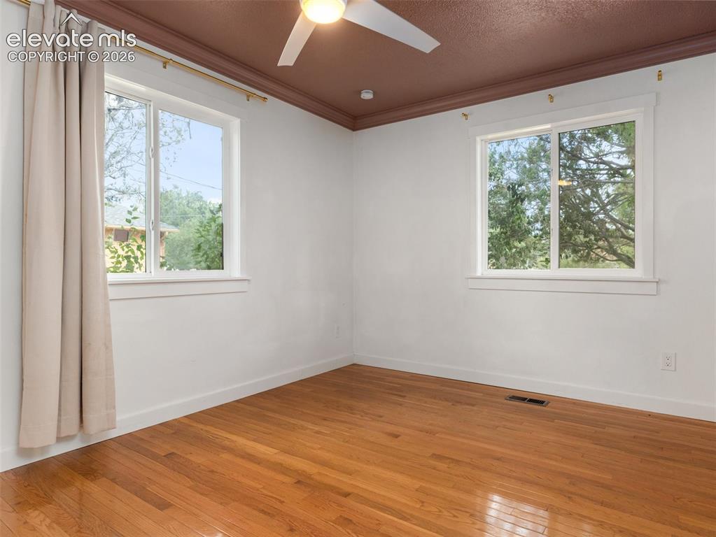 Image 22 of 35: Room featuring wood-finish flooring and a ceiling fan