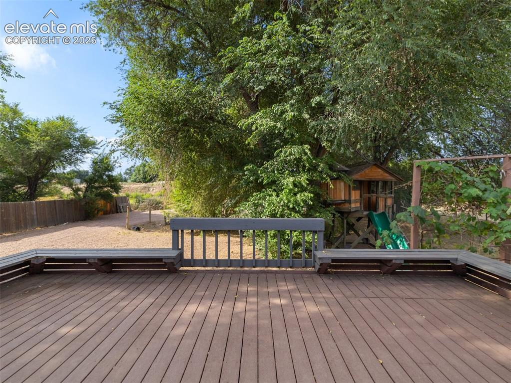 Image 26 of 35: Expansive outdoor deck featuring wood-finish composite decking, integrated 